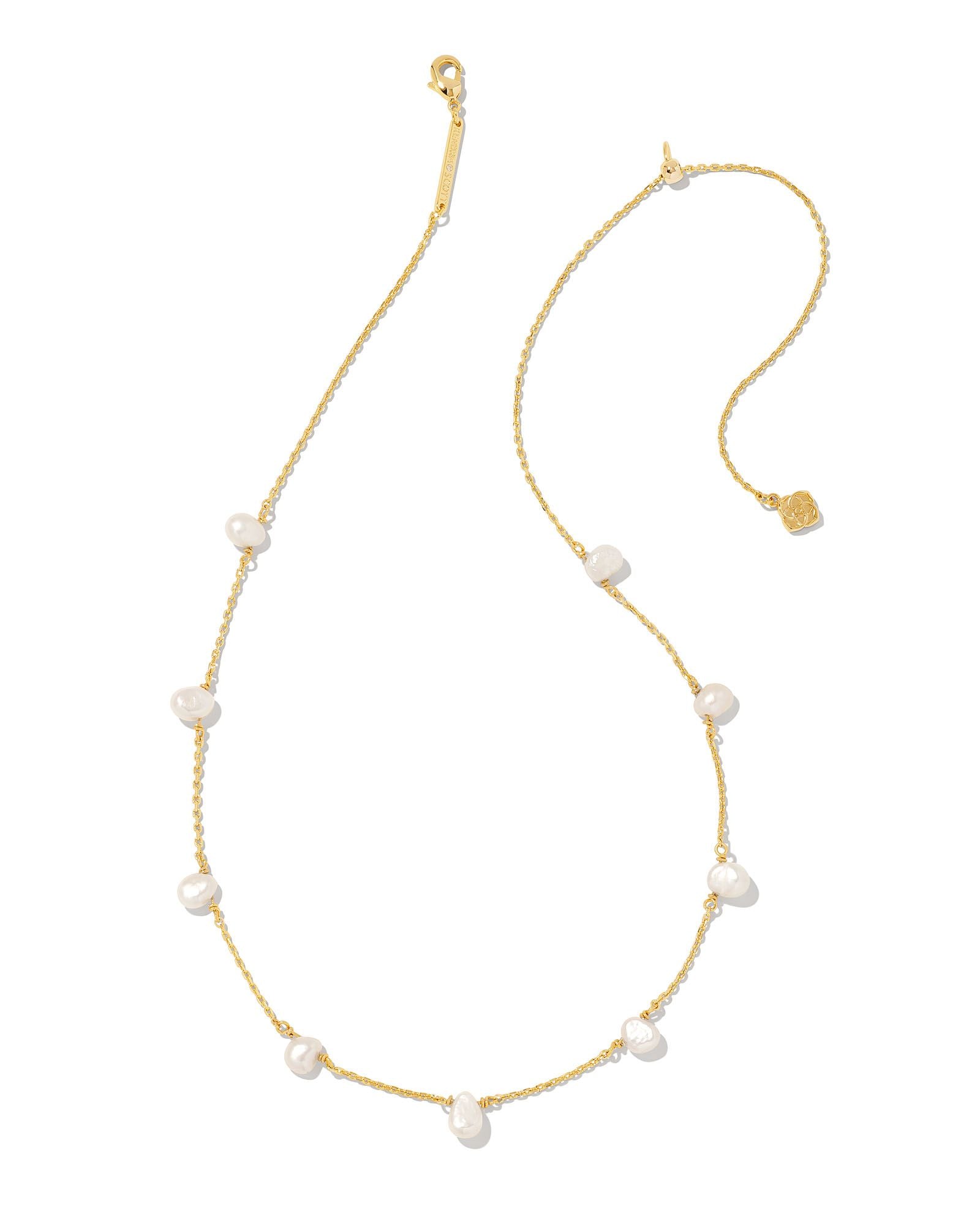 Gold necklace with pearls on a white background